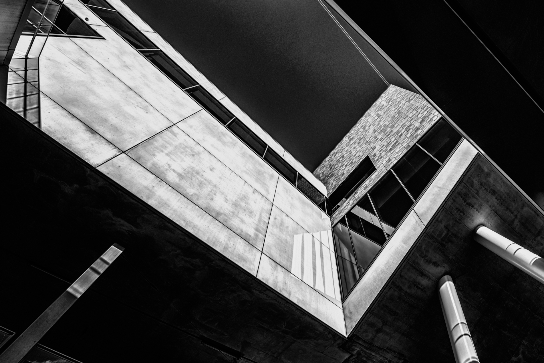Greyscale low angle shot of a building with cool design